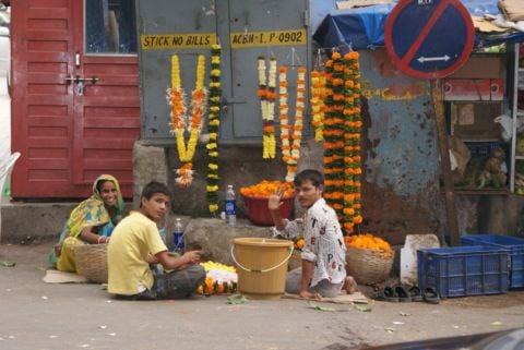 Flower vendors use the side walk to assemble garlands in Mumbai - photo Rahul Mehrotra
