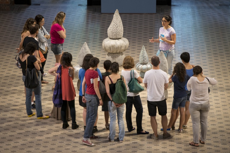 Erika Verzutti, Venus Yogi, 2013. Exhibition view: 9th Mercosul Biennial, Porto Alegre, Rio Grande do Sul. From left: Participants in the event with mediator Martha Stone Jacondino. Photo: indicefoto