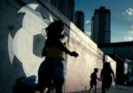 BRAZIL. Sao Paulo. June 13 2014. Women and child running in Cambuci neighborhood. Film still. © Jonas BendiksenMagnum Photos Il bello e il brutto dei Mondiali di Calcio in Brasile. A Torino due mostre della Magnum da Adplog, lo spazio di Alessandro Del Piero. Prove generali per il futuro Centro Italiano per la Fotografia Camera