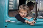 Steve McCurry, A farmer's son in his father's truck, Lambari, Brazil, 2010