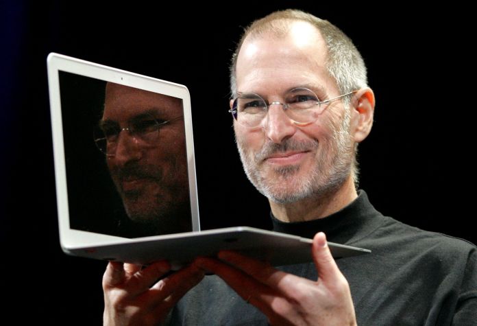 Apple CEO Steve Jobs holds up the new MacBook Air after giving the keynote address at the Apple MacWorld Conference in San Francisco, Tuesday, Jan. 15, 2008. The super-slim new laptop is less than an inch thick and turns on the moment it's opened. (AP Photo/Jeff Chiu)