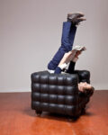 Seeking comfort in an uncomfortable chair. Photo Kristof Vrancken, performer Seppe Baeyens. Courtesy Z33, Hasselt