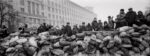 Pavel Wolberg, Ukrainian civilians stand behind a barricade as they watch riot police lines near the Maidan square in Kiev, 2014 © Pavel Wolberg, Prix Pictet 2017