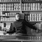 David Goldblatt, Shop assistant, Orlando West, 1972, silver gelatin photograph on fibre-based paper. Image courtesy Goodman Gallery, Johannesburg and Cape Town © The David Goldblatt Legacy Trust