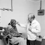 David Goldblatt, Eyesight testing at the Vosloosrus Eye Clinic of the Boksburg Lions Club 1980, silver gelatin photograph on fibre-based paper. Image courtesy Goodman Gallery, Johannesburg and Cape Town © The David Goldblatt Legacy Trust