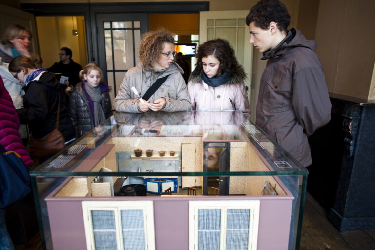 Visitors looking at scale models of the Secret Annex © Anne Frank House. Photographer Cris Toala Olivares