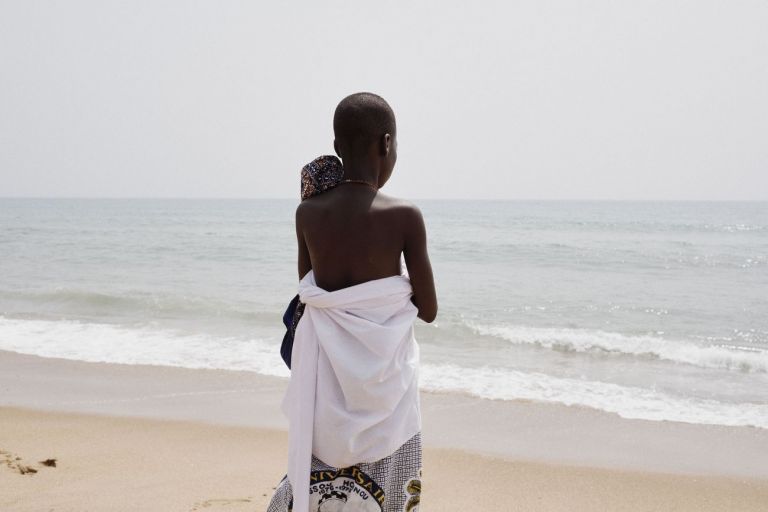 Francesco Bellina, A boy observes the sea during a voodoo ritual held on the beach. The Ocean is considered to be a divinity, Mami Waté, the Mother of the Water. Ouidah, Benin, 10th January 2018
