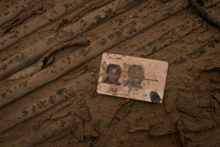 Francesco Bellina, The identity document of a Cameroonian woman, inside one of the pickup trucks confiscated from traffickers. Agadez, Niger, 2018