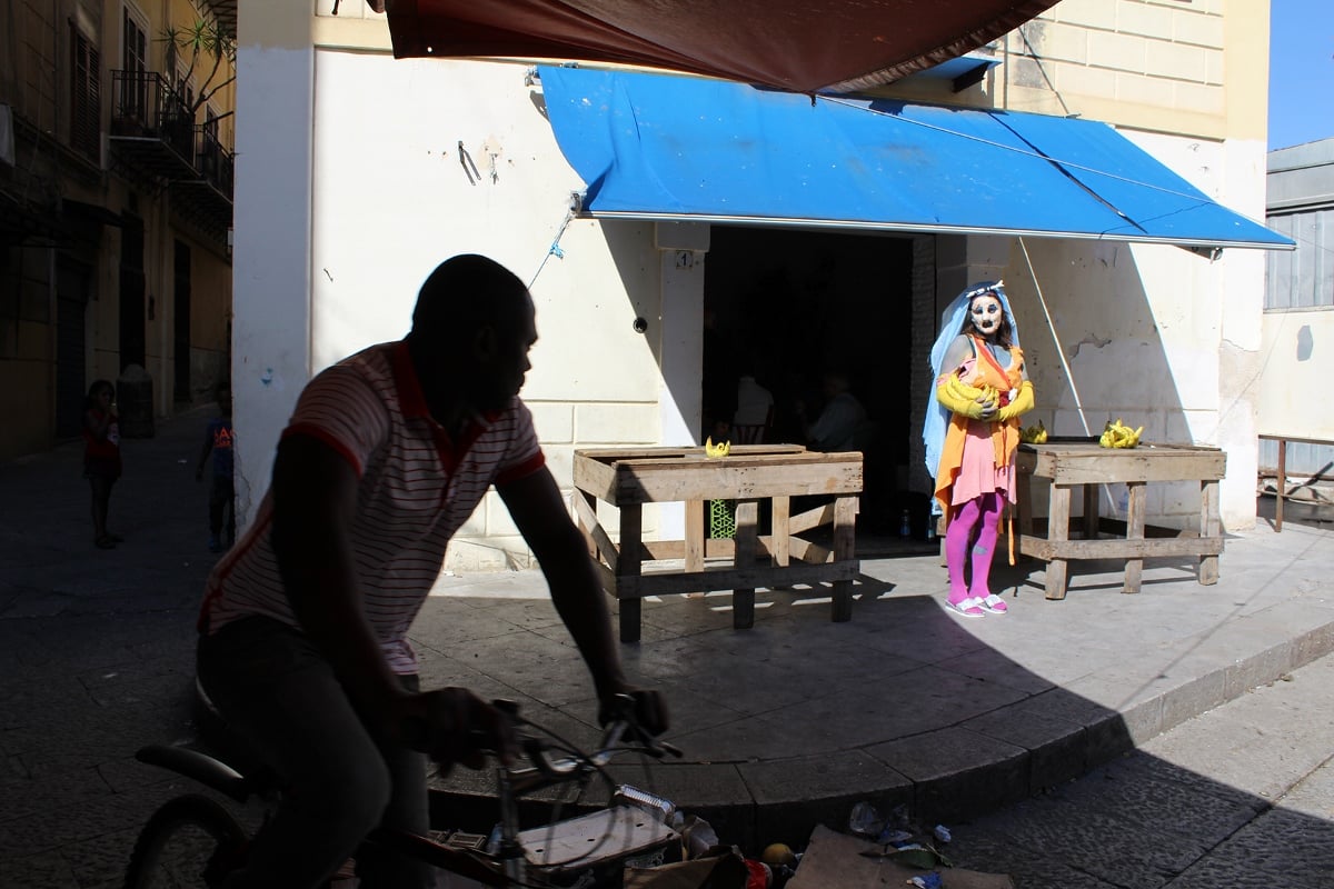 Bite The Saurus, Nschotschi Haslinger, Banana Orbit, 2018, performance view at Mercato Ballarò, May the bridges I burn light the way, EXILE at Manifesta 12, Palermo, courtesy the artist and EXILE 