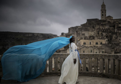 ph. Marco Longari Senegalese Absa Tall (19), wears a creation by Ivorian maitre couturier Ibrahim Savane of the Silent Academy, on April 04, 2019 in front of the Convent of Saint Agostino in Matera landmark “Sassi”.