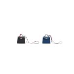 A Black Tadelakt Leather Kelly Twilly Bag Charm With Gold Hardware & A Blue Izmir Tadelakt Leather Kelly Twilly Bag Charm With Gold Hardware. Hermès, 2019. Courtesy Christie's
