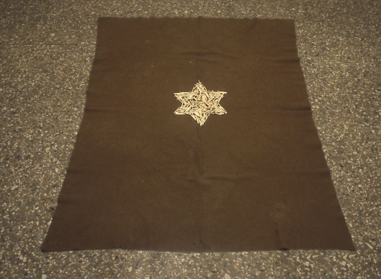 Mel Bochner, Yiskor (For the Jews of Rome), 1993, Burnt matchsticks on army blanket on floor, 60 x 50 1/2 in. (152.4 x 128.3 cm). Courtesy the artist