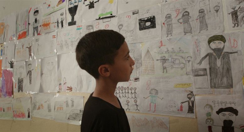 Notturno a fim by Gianfranco Rosi il bambino Fawaz senza parole davanti ai disegni dei bambini che raccontano gli orrori dell’Isis