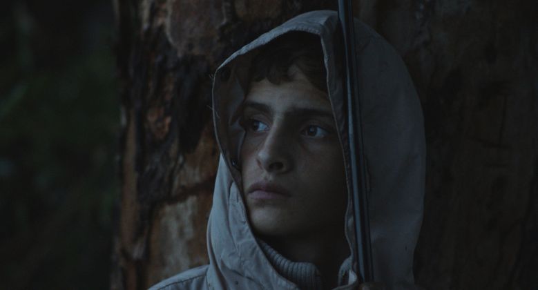 Notturno a film by Gianfranco Rosi. Alì si ripara da una tempesta di vento e pioggia – Libano confine con Siria