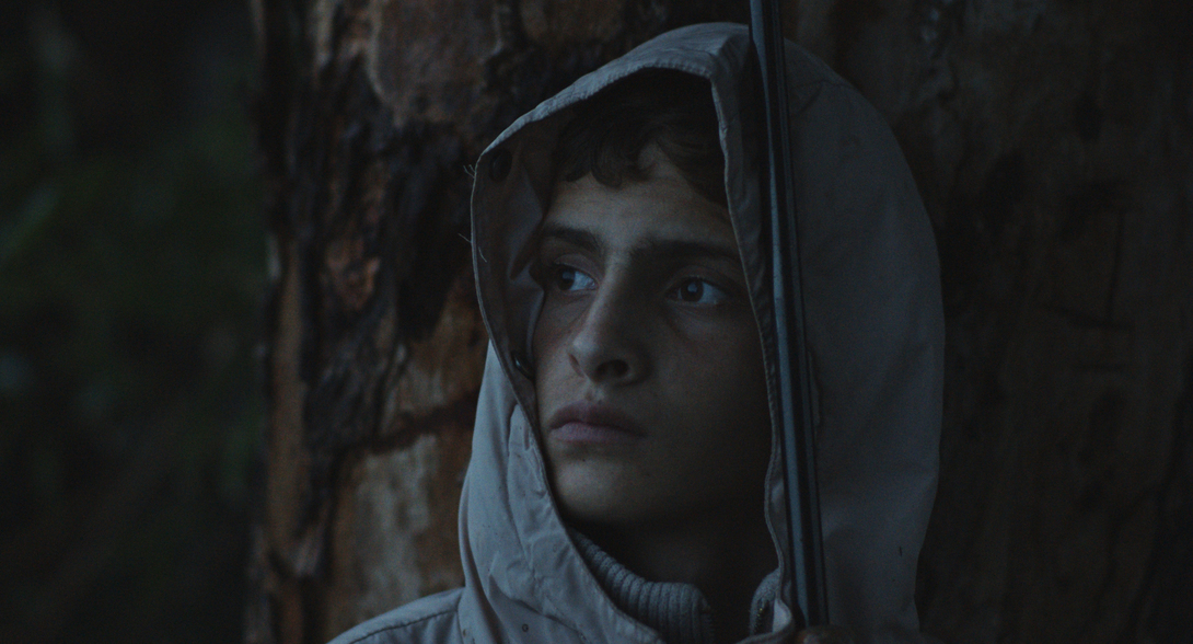 Notturno a film by Gianfranco Rosi. Alì si ripara da una tempesta di vento e pioggia – Libano confine con Siria