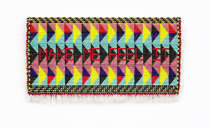Jeffrey Gibson Make Me Feel It​, 2015 Artificial sinew, glass beads, nylon fringe, steel and brass studs, and tin jingles on acrylic felt, mounted on canvas 21 5/8 x 55 in. (55 x 140 cm) Courtesy of the artist and Palazzo Monti