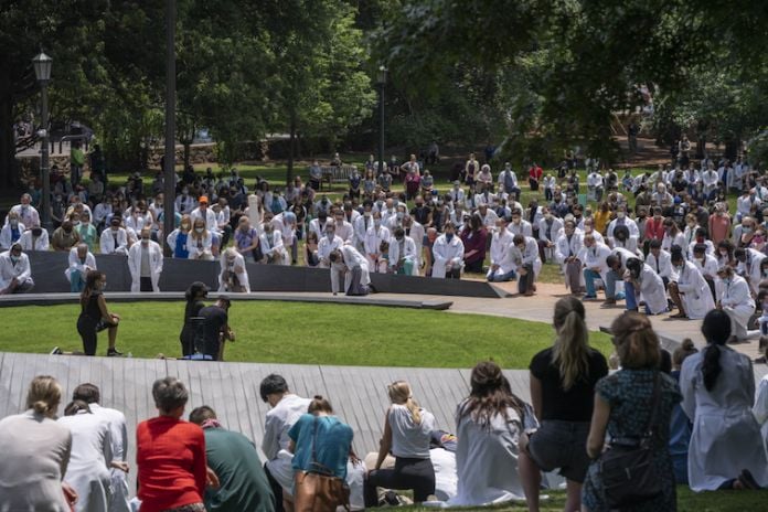 UVA medical students gathered at the Memorial to Enslaved Laborers and took a knee for nine minutes on June 5, 2020 (photograph by Sanjay Suchak / UVA Communications)