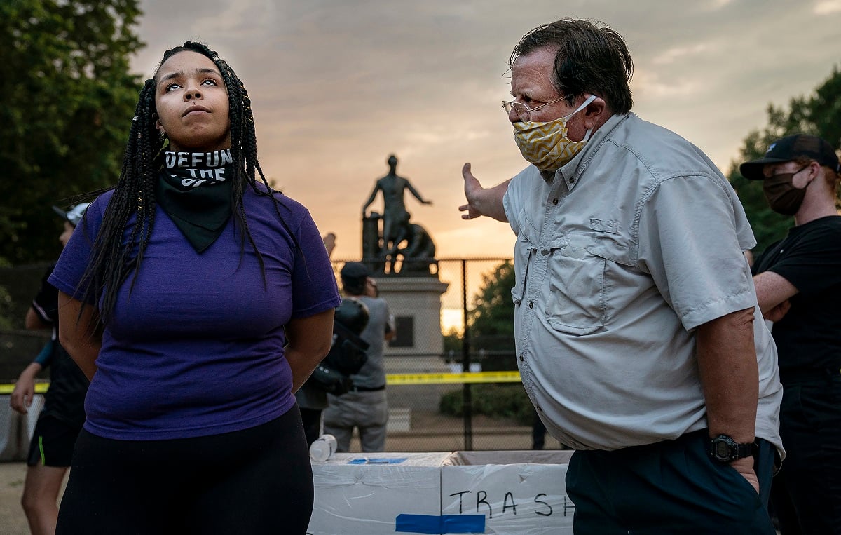 Anais, 26, who wants to remove the Emancipation statue in Lincoln Park in Washington, DC, argues with a man who argues to keep it, June 25th, 2020. Critics say the Emancipation Memorial — which shows Lincoln holding a copy of the Emancipation Proclamation as an African American man in a loincloth kneels at his feet — is demeaning in its depiction of African Americans. The drive to remove the statue comes amid a wave of calls to take down monuments of Confederate generals.