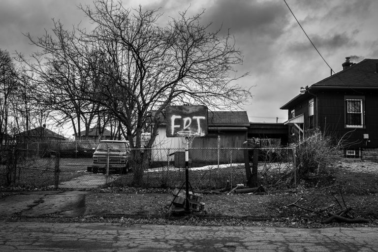 Those Who Stay Will Be Champions © Chris Donovan, Canada. A basketball net supported by cinder blocks stands beside a street in Flint, on 25 February 2020. The board reads ‘FDT’, an acronym based on a popular anti-Donald Trump protest song.