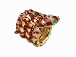 Serpenti bracelet watch in yellow gold with brownish, red enamel, emeralds and diamonds, ca 1970