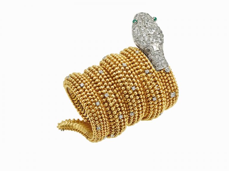 Serpenti bracelet watch in gold with emeralds eyes and diamonds, ca 1955