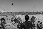 CHILDREN PLAY WITH KITES IN POLISHINA INFORMAL SETTLEMENT BY LORENZO TUGNOLI