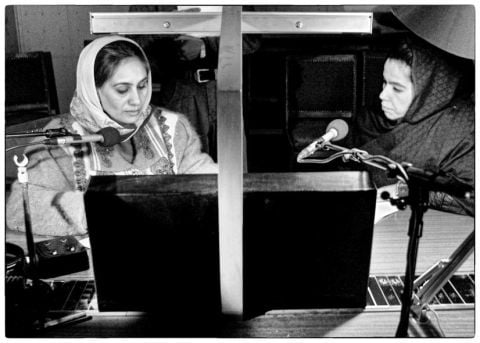 Afghan radio womans presenters Jamila Restin (L) and Farida Helleh read the news at "Good Moorning Afghanistan" Radio in Kabul, February 25, 2002. The one hour radio show, a mixture of news, interviews and feature packages, breaks the mould of Afghan broadcasting which traditionally focuses on government propaganda and Islamic teachings. REUTERS/Mario Laporta z