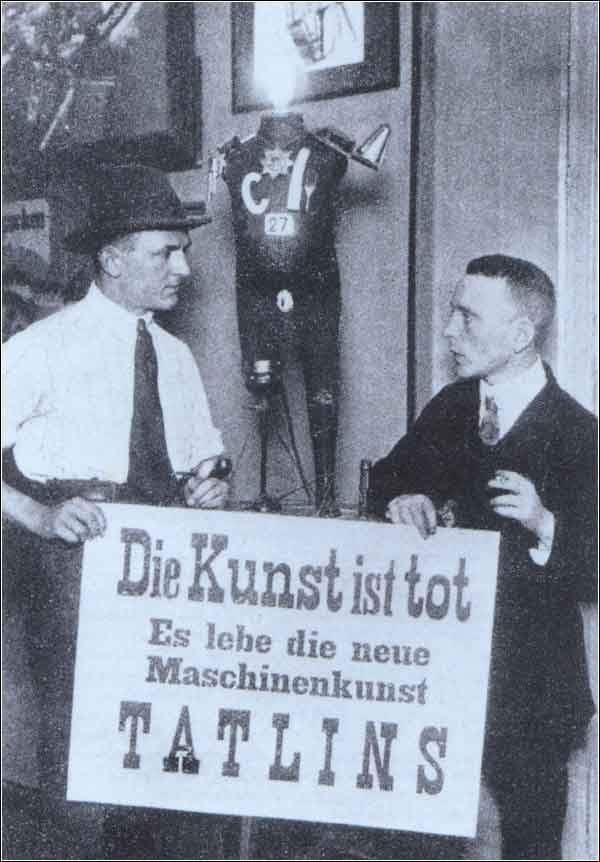 George Grosz (sx) e John Heartfield (dx) alla Prima Mostra Internazionale Dada, Berlino, giugno 1920. Sul cartello è scritto “L’arte è morta. Viva la nuova arte meccanica di Tatlin”