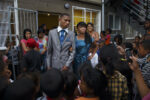 CAPE TOWN, MANENBERG, SOUTH AFRICA - As Lauren-Lee (Lolla) and her prom date walk out of the house everyone cheers at them. The whole neighborhood is standing beneath the rows of clotheslines that run between the two Joyce Court buildings. Everyone wants to see Lolla walk out of the house in her ball gown. CREDIT: Ilvy Njiokiktjien