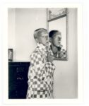 Claude Cahun, Self portrait (reflected image in mirror, checquered jacket), 1928. Courtesy of the Jersey Heritage Collections