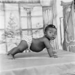 James Barnor, Baby on All Fours, Eric Nii Addoquaye Ankhra, Ever Young Studio, Accra, 1952 ca., Modern Silver Gelatin Print © James Barnor. Courtesy galerie Clémentine de la Féronnière, Paris