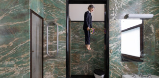 MAURIZIO CATTELAN YOU, 2021 PLATINUM SILICONE, EPOXY FIBERGLASS, STAINLESS STEEL, REAL HAIR, CLOTHES, HEMP ROPE AND FLOWERS 140 × 40 × 25 CM : 55 × 15 3:4 × 10 INCHES. Credits by Roberto Marossi. Courtesy the artist and MASSIMODECARLO