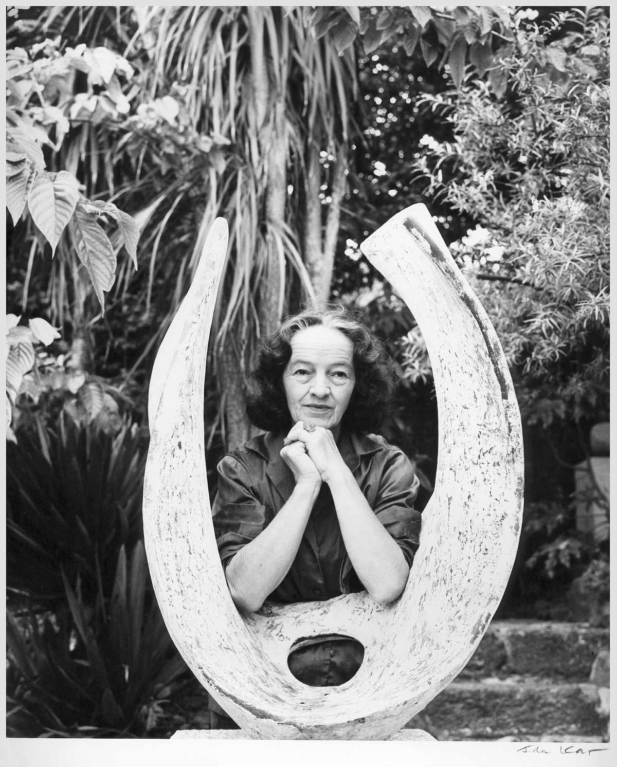 Barbara Hepworth with Curved Form (Trevalgan) in the garden of Trewyn Studio, St Ives, by Ida Kar 1961. Courtesy National Portrait Gallery London