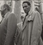 Dorothea Lange, New York City (Man in Raincoat) (1952). Courtesy of Phillips