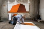 Christo in his studio working on a preparatory drawing for The Mastaba New York