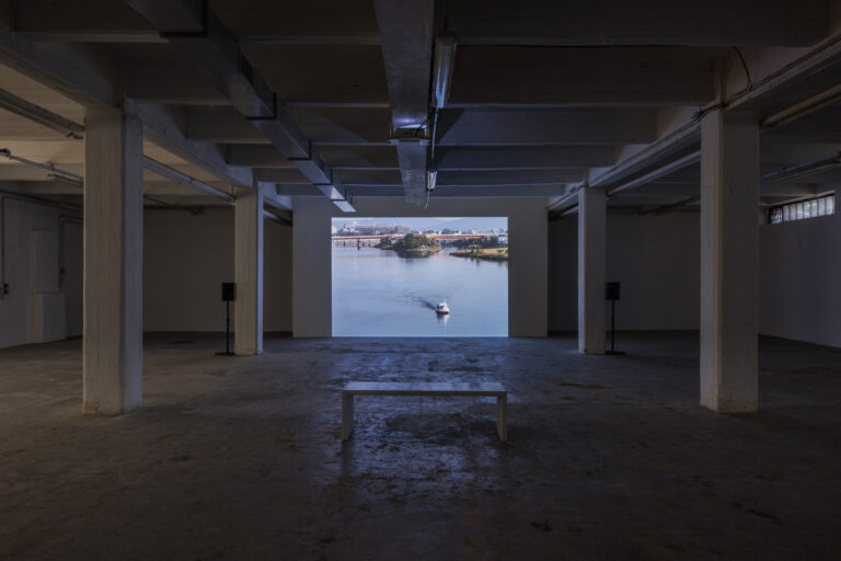 Shimabuku, Swan Goes to the Sea, 2012-2014, video, poster, testo in vinile sul muro, installation view at ZERO..., Milano, 2023