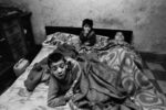 La donna e i suoi bambini stanno sempre a letto. In casa non ci sono né luce né acqua. Palermo, 1978 ©Archivio Letizia Battaglia