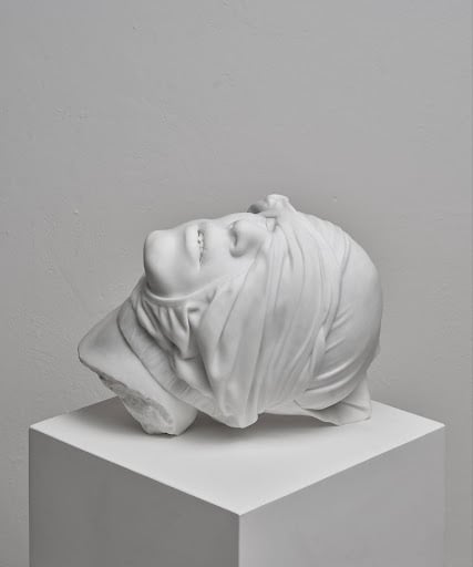Reza Aramesh, “Action 241: Study of the Head as Cultural Artefacts” 2023. Hand carved and polished Bianco Michelangelo marble, 32 x 40.8 x 31.2 cm. Edition 1 of 3 + AP. Photograph by Laura Veschi. Courtesy of Reza Aramesh Studio