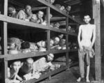 Margaret Bourke-White, Half-starved slave laborers lying in wooden bunks incl. future Nazi-hunter Elie Wiesel (2nd Row-7L) looking amazed at their liberators, US troops of the 80th Army Div. entered their barracks, in Buchenwald concentration camp. Jena, Germany, 1945. Margaret Bourke-White/The LIFE Picture Collection/Shutterstock