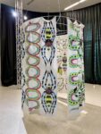 Sophie Lazari, Ritus resurrectionis, 2024, Metallo, pittura tessile su stoffa, luci LED:4 banners ciascuno, Struttura circolare, Sound Flavia Laus, Courtesy of the artist