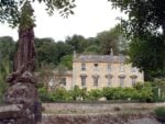 Iford Manor with statue on the River Frome