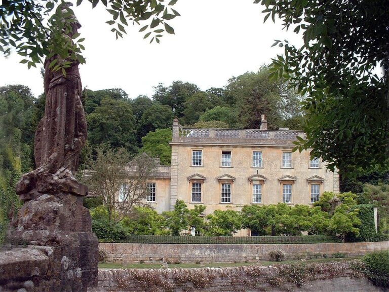 Iford Manor with statue on the River Frome