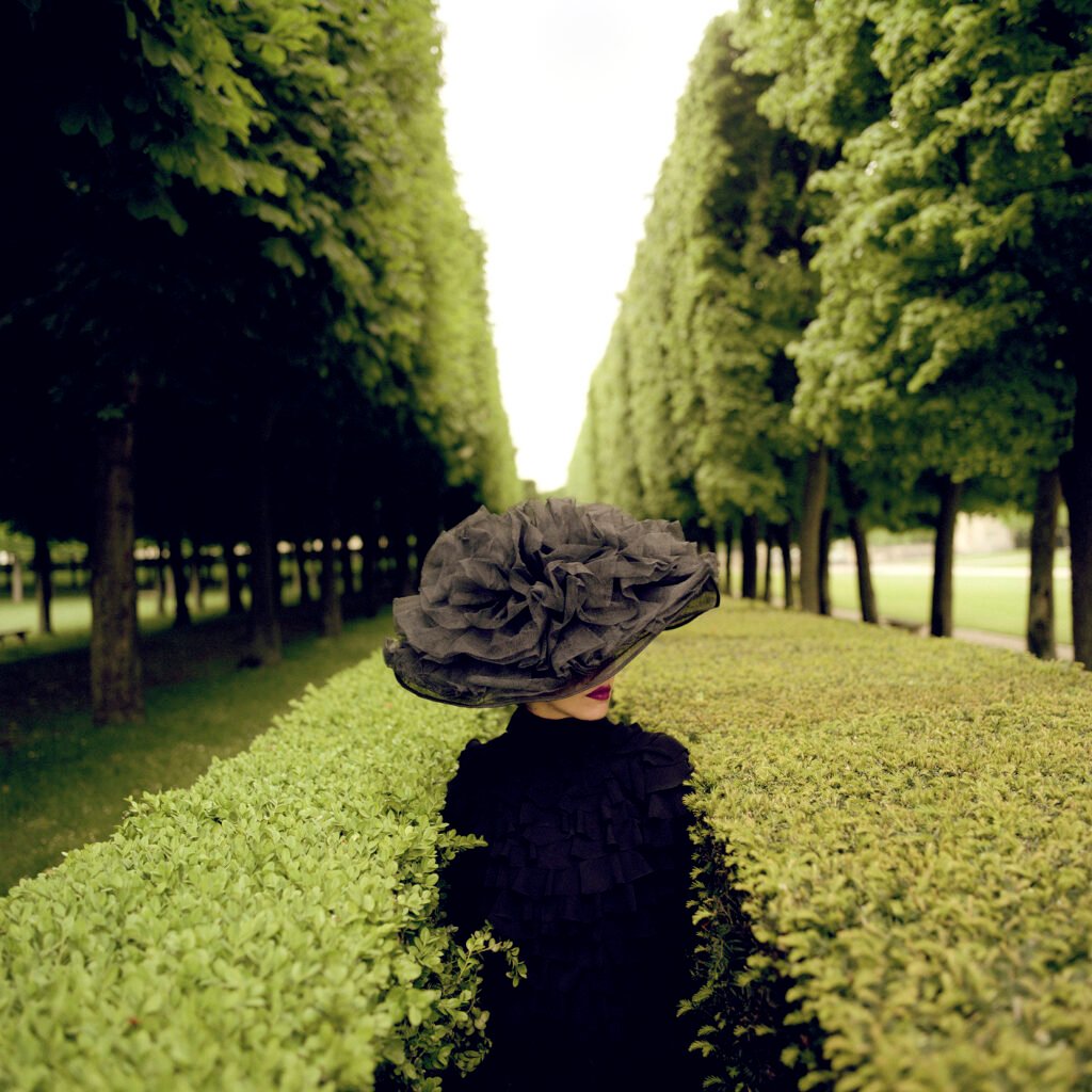 Woman with Hat between Hedges, Parc de Sceaux, France, 2004. Credits: Rodney Smith