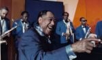 Duke Ellington in the movie Jazz Odyssey, @Louis Panassié, CC BY-SA 3.0, via Wikimedia Commons