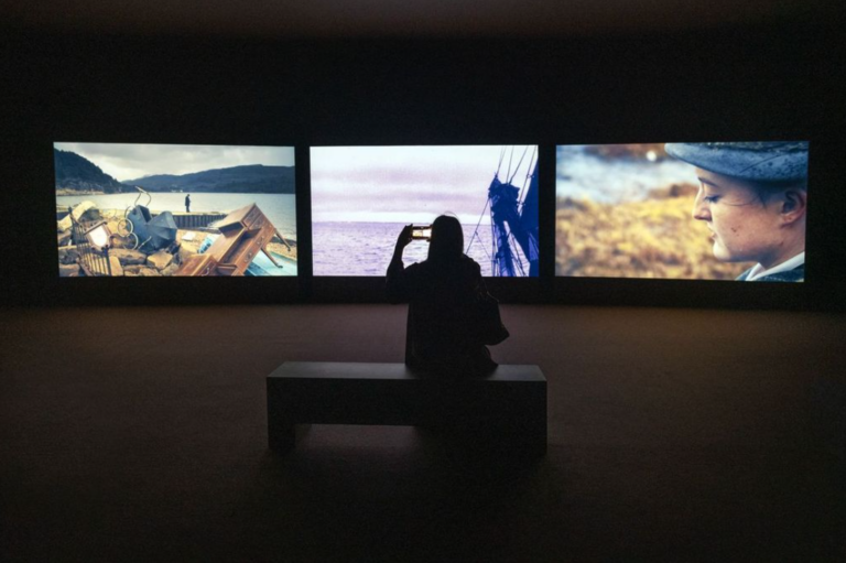 John Akomfrah, Vertigo Sea, 2015. Made in association with Sharjah Art Foundation and supported by the BBC Natural History Unit; Arts Council England; British Film Institute; Baltic Art Centre; Bildmuseet, Umeå; Swedish Arts Council; and Tyneside Cinema Gallery. Sharjah Art Foundation Collection. Installation view: Of Land and Water: Works from the Sharjah Art Foundation Collection, Kalba Ice Factory, Kalba, 2025. Image courtesy of Sharjah Art Foundation. Photo: Motaz Mawid