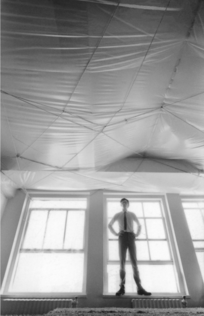 Christo with his Wrapped Ceiling (1965) in a Midtown Manhattan office building, New York, 1965. Artwork &copy; Christo and Jeanne-Claude Foundation. Photo Thomas Cugini