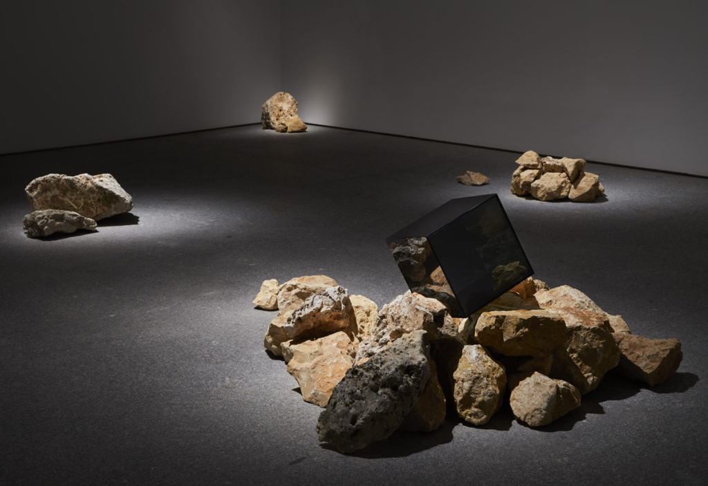 Grada Kilomba, Compressed Time, 2024 _ Installation with limestone boulders and black glass cube, dimensions variable _ Installation view at Museo Nacional Centro de Arte Reina Sofía, Madrid, 2024