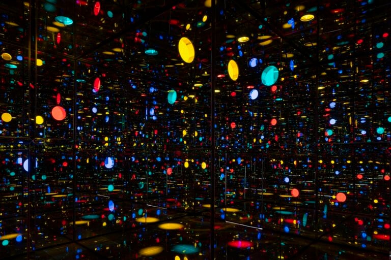 Yayoi Kusama, Infinity Mirrored Room&mdash;Illusion Inside the Heart, 2025. Mirror polished stainless steel with glass mirrors and colored acrylic, 300 &times; 300 &times; 300 cm, inside view. Collection of the artist. Courtesy of Ota Fine Arts. Photo: Peter Tijhuis &copy; YAYOI KUSAMA